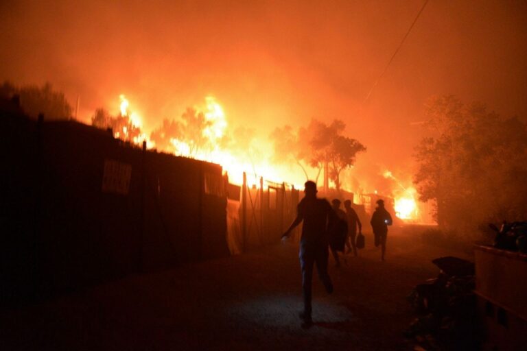 Migrants flee burning camp during lockdown